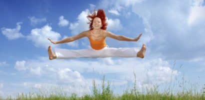 Lady jumping against blue sky