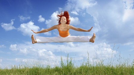 Lady jumping against blue sky